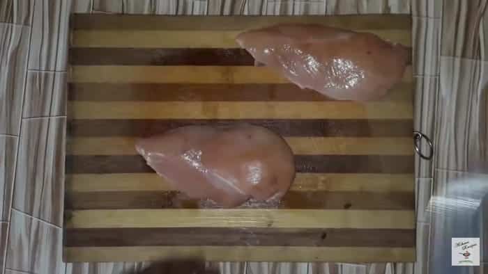cut the chicken breast into two halves