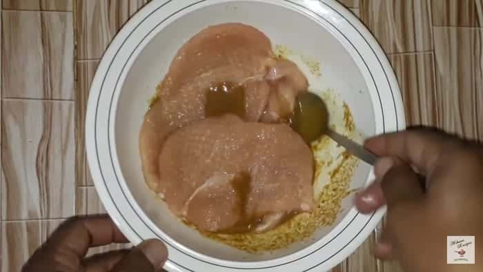 immersing the chicken steaks in the marinade