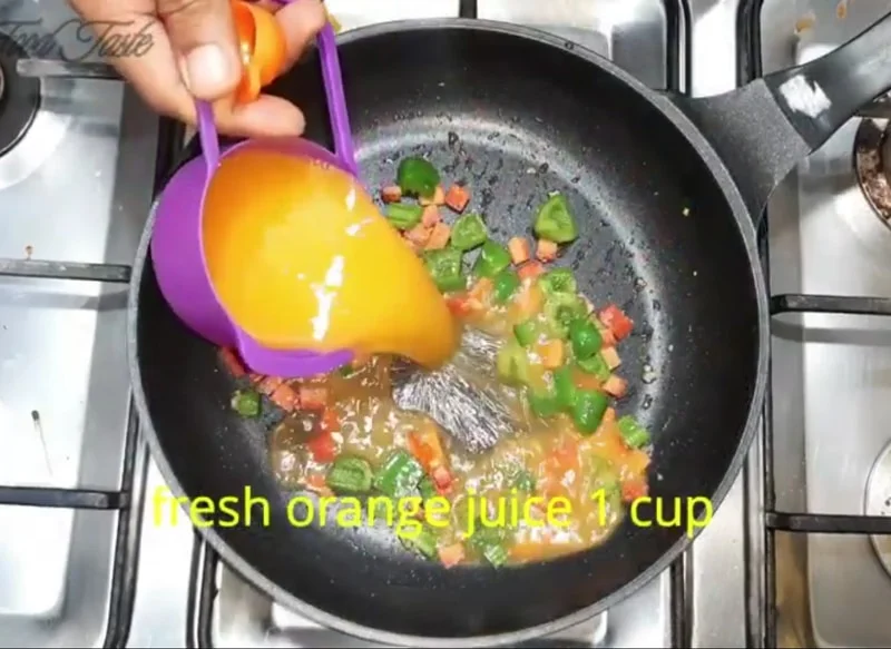 Fresh orange juice added to orange vegetable sauce for fish