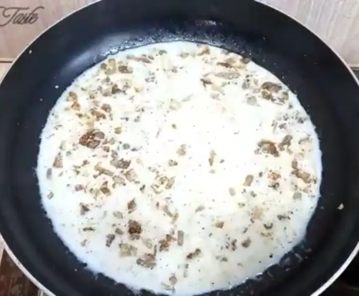 adding milk to onion and seasoning