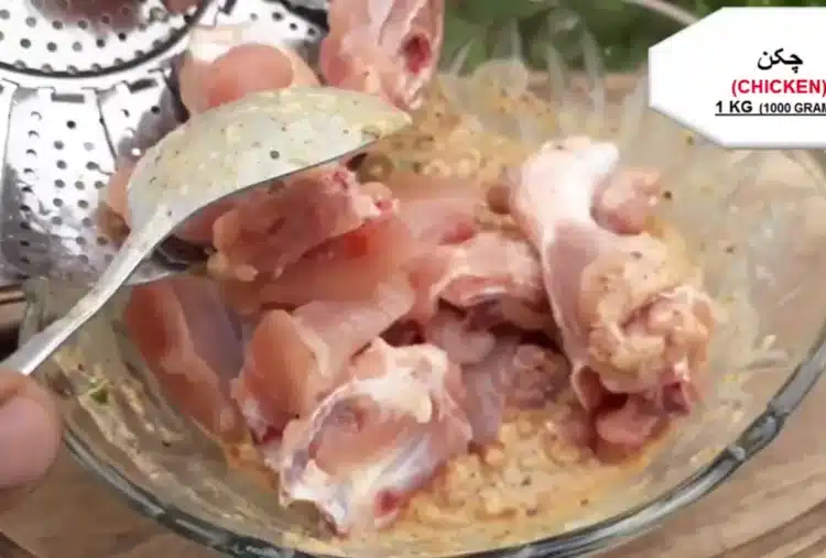 coating chicken with the marinade