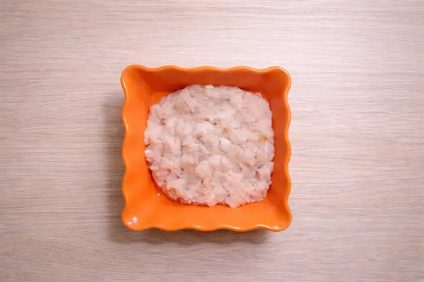 Freshly prepared chicken mince in a bowl for mince pizza topping