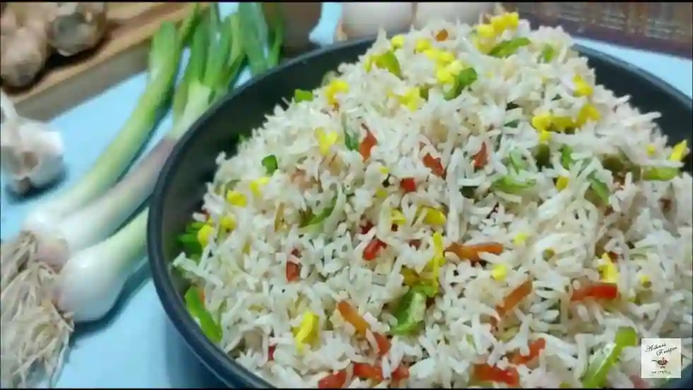 fried rice in a serving dish alongside spring onions