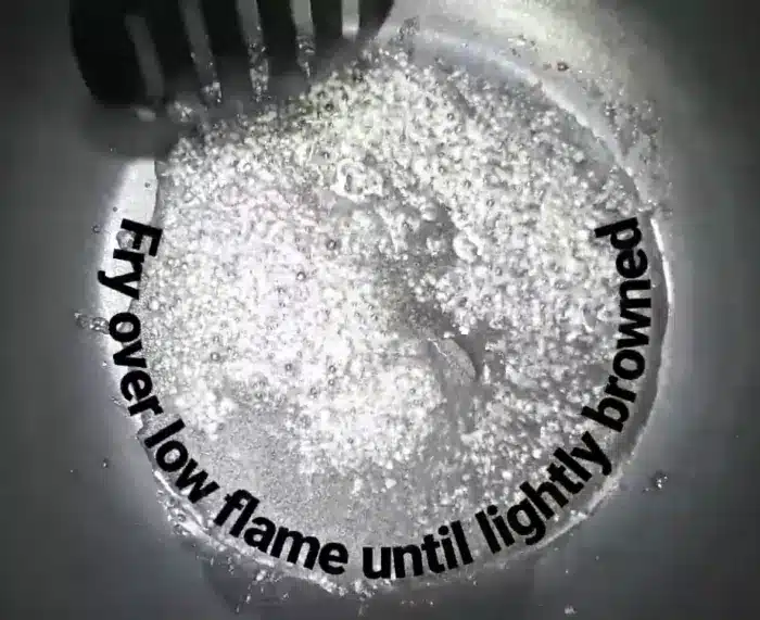 heat cooking oil in a non-stick pan and fry garlic paste till lightly browned