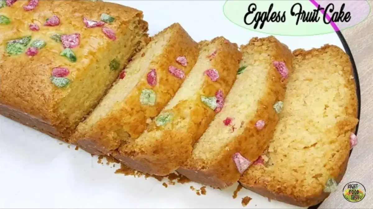 Slices of eggless fruit cake baked without an oven, loaded with candied fruits and nuts