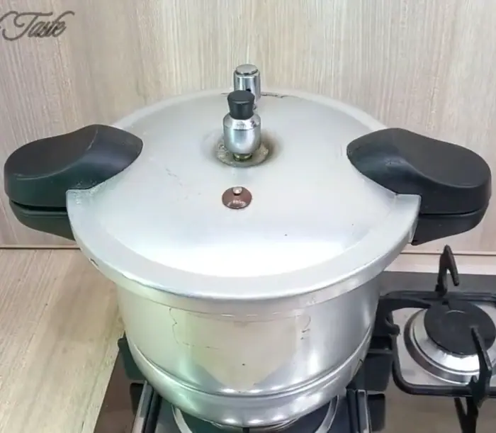 pressure cooker with its closed lid to initiate the tenderization process