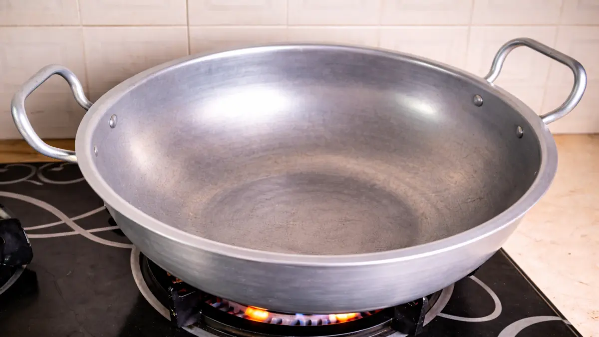 preheating a wok on the stovetop before baking a cake