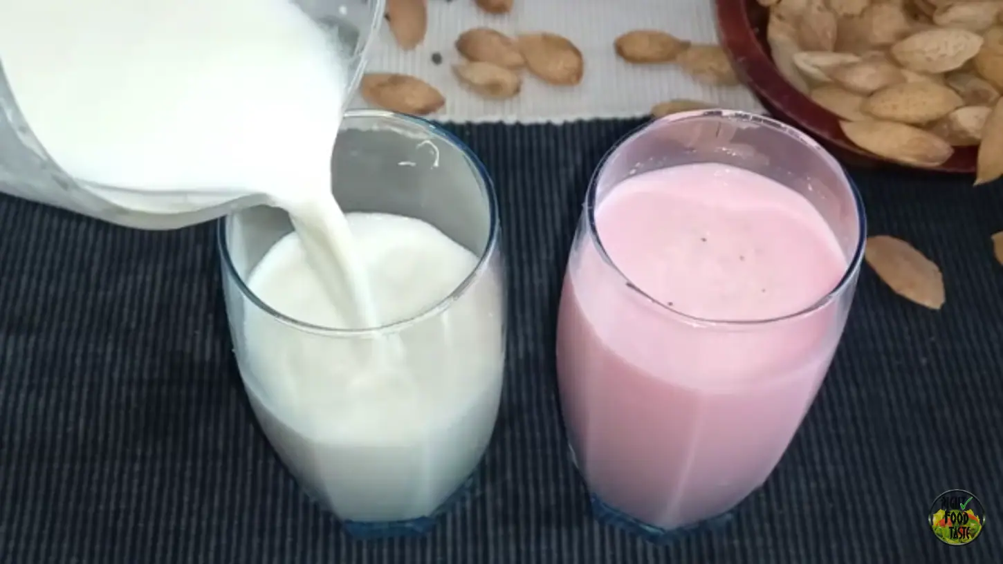 thandai recipe featured image showing two tall glasses filled with thandai