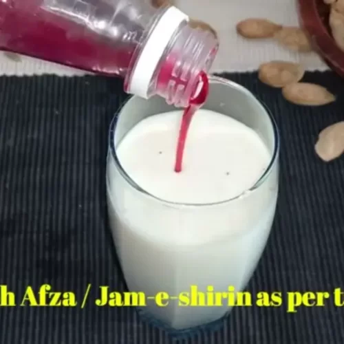mixing rooh afza syrup with thandai drink