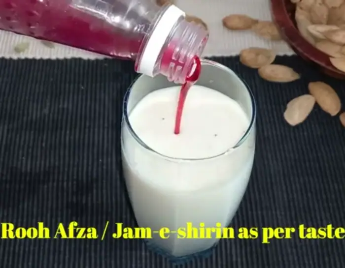 mixing rooh afza syrup with thandai drink