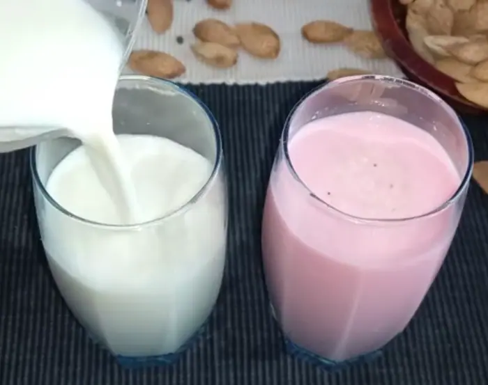 serving the thandai drink in tall glasses